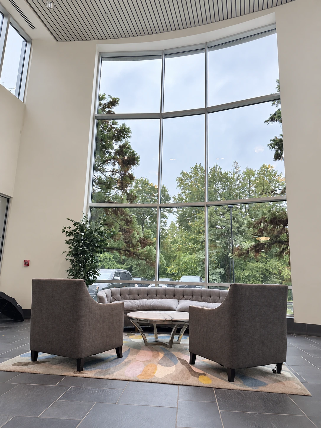 Lobby lounge with seating beside tall windows
