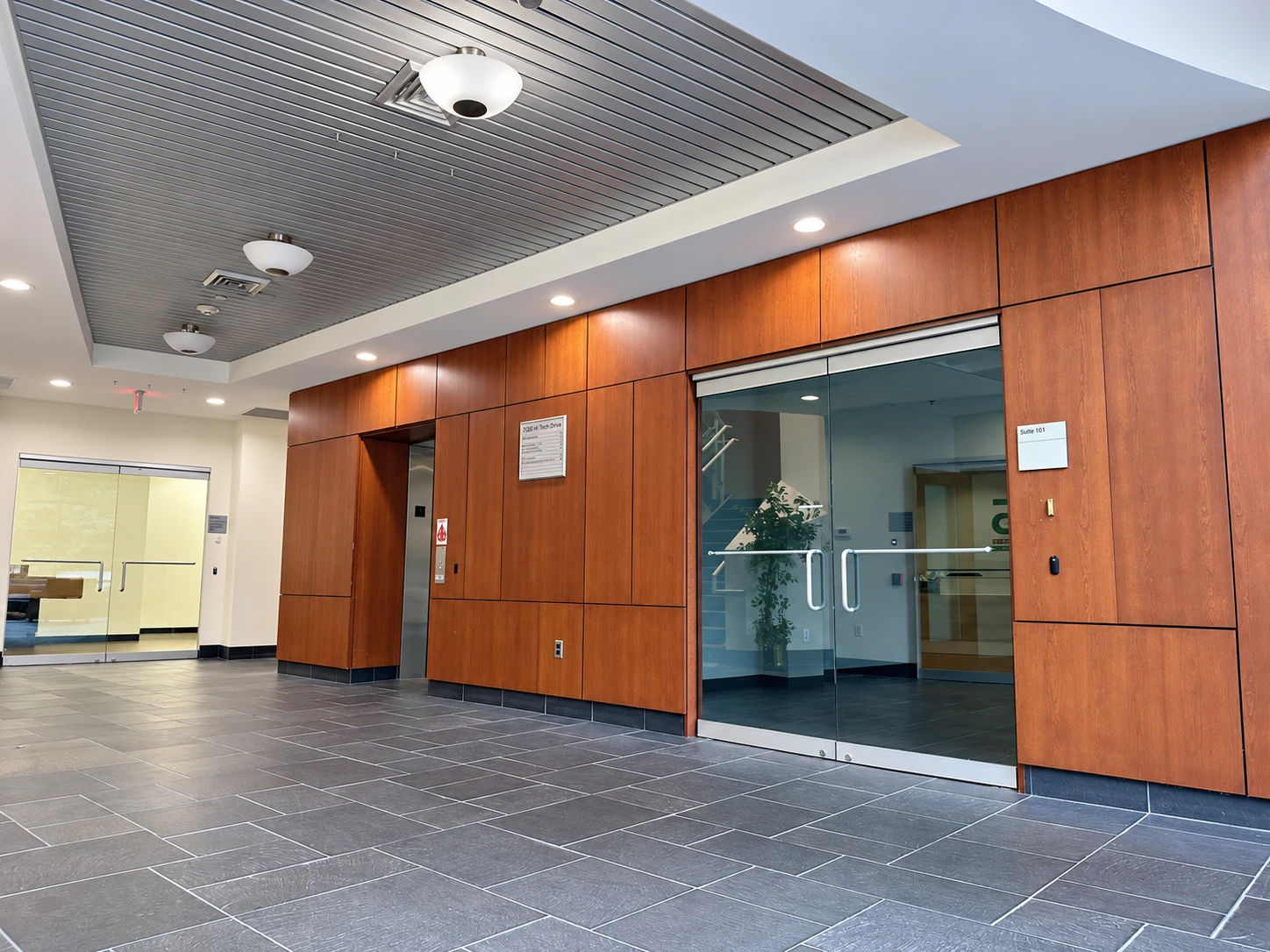 Main lobby with wood-paneled walls and tiled flooring